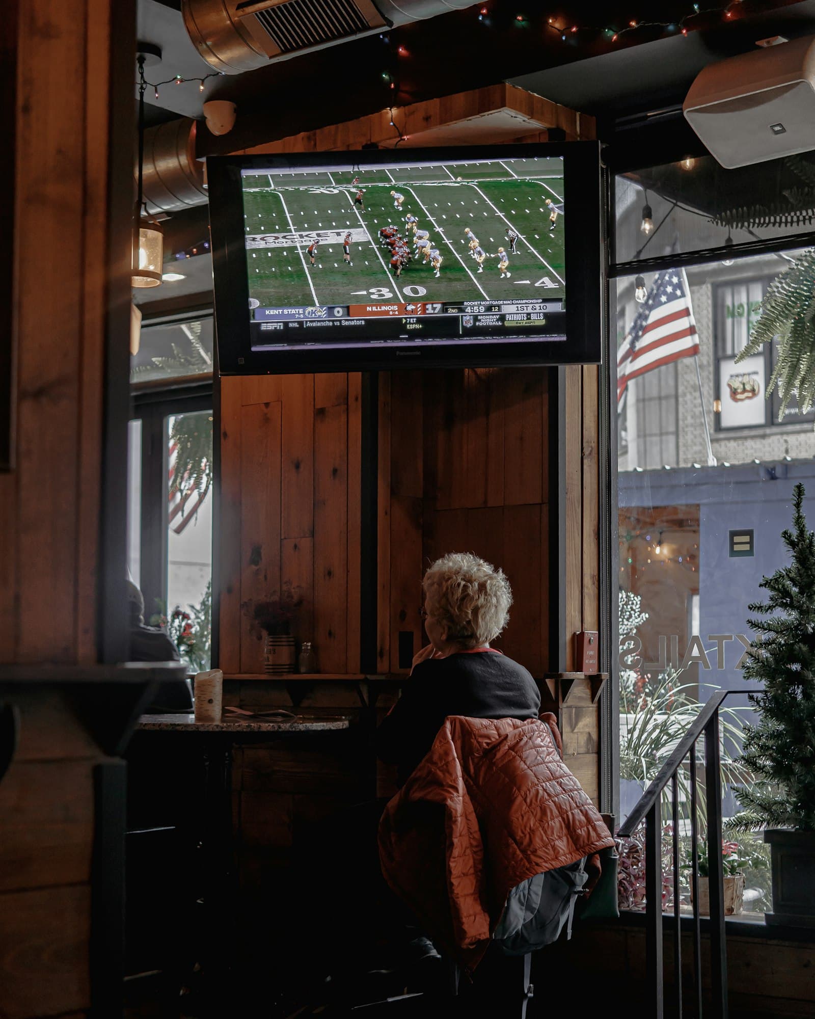Upscale restaurant bar interior with backlit shelving, a typical commercial setting for mounted displays