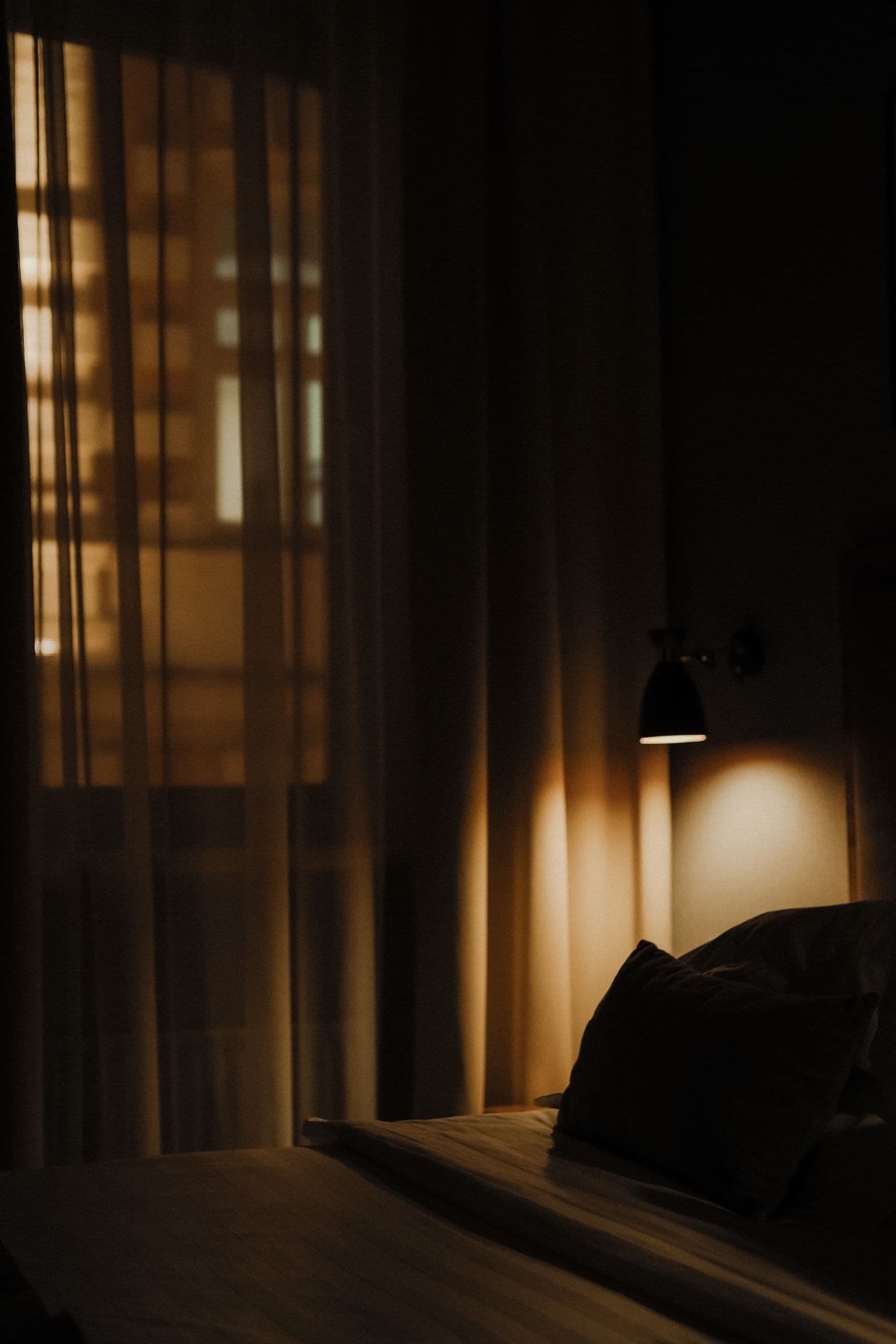 Composed, dimly lit room with heavy drapery, the kind of layered interior styling found in River Oaks homes